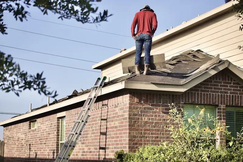 Professional roofer working on a residential roof in Oak Grove Inn